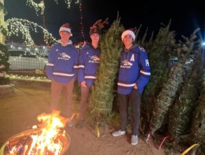 Bishop Broncos Ice Hockey Team helping load Christmas Trees
